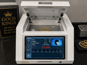 Desktop XRF analyzer testing gold jewelry at Gold Kings and displaying the gold content and karat on its built-in screen.